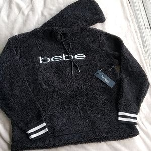 Beautiful black and white bebe fleece top with tags..
